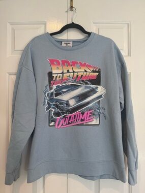 Universal Light Blue Graphic Tee with Pink Accent